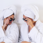 two ladies wearing shades and white robe in spa