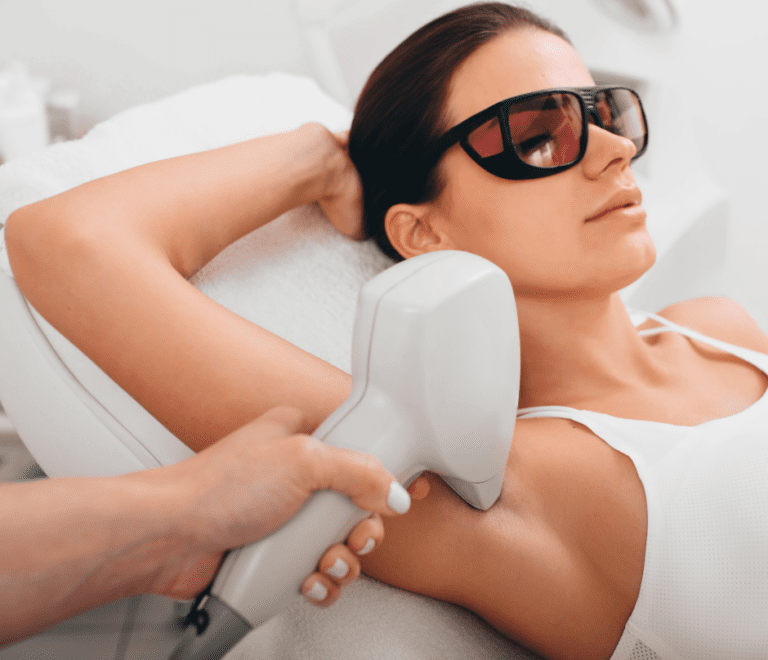 The woman is having laser hair removal performed on her armpit