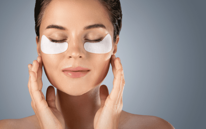 woman with hydrating eye patches under her eyes