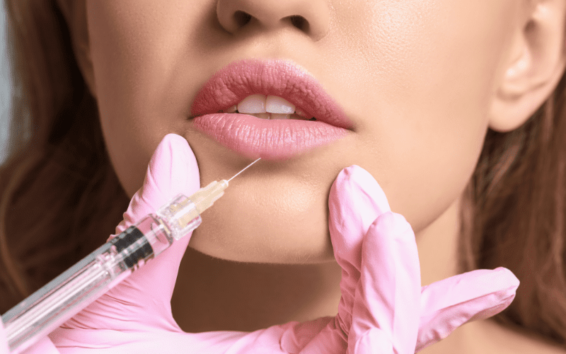 needle injected into a young woman's lips