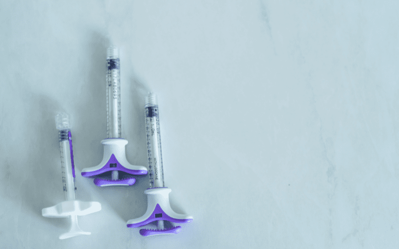 group of plastic syringes for filler injection on white background