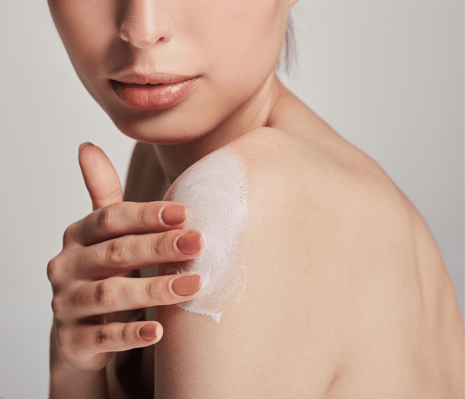woman applying moisturizer to her skin