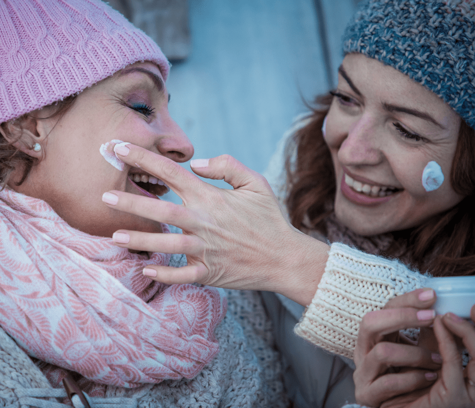 women putting a moisturizer on their face