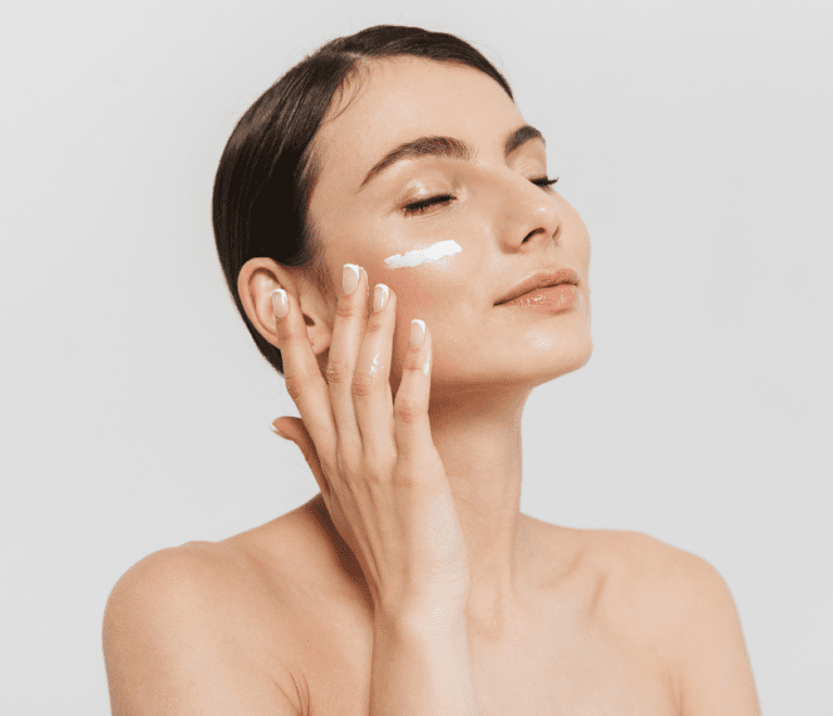 woman applying skincare to her face
