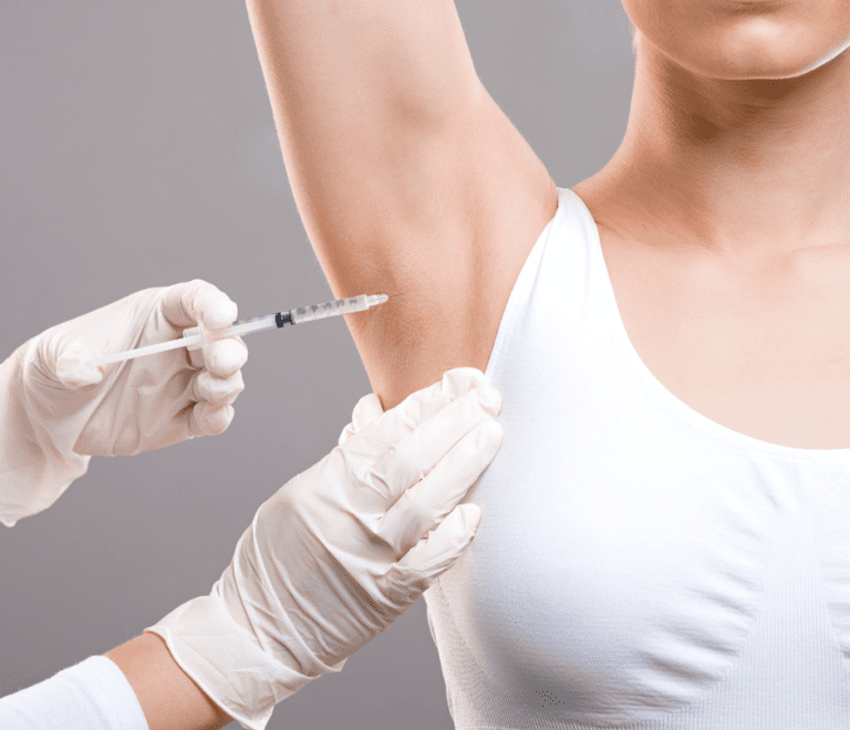 a doctor injecting a patient in the armpit