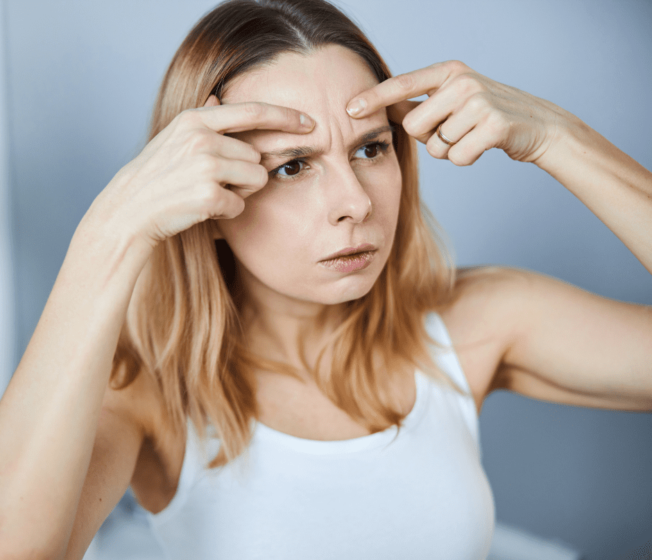 woman checking her forehead wrinkles
