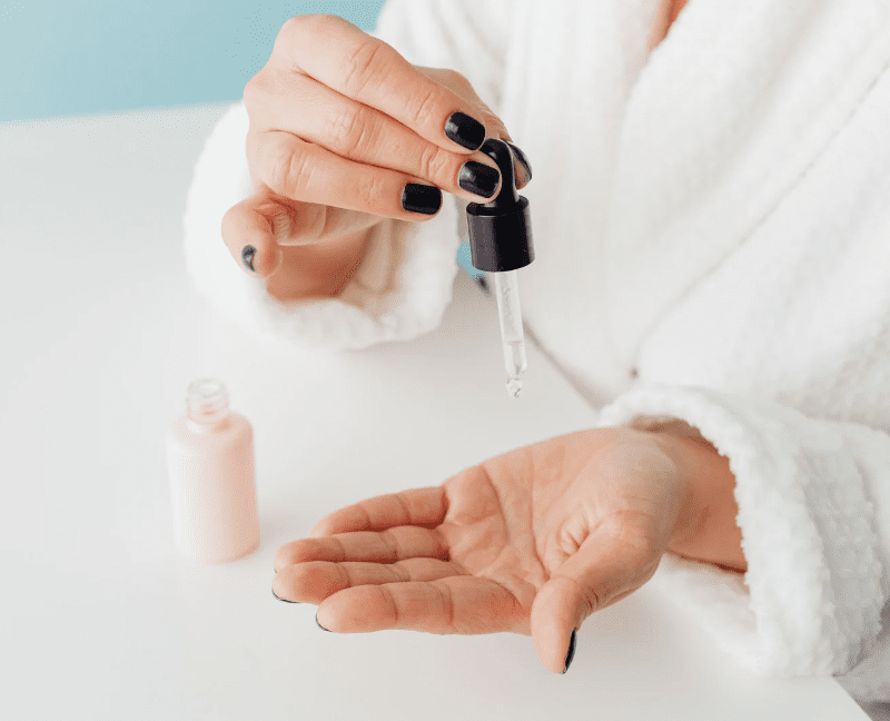 woman hands applying serum skincare on skin