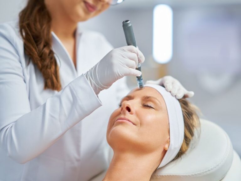 dermatologist applying microneedling on woman's face