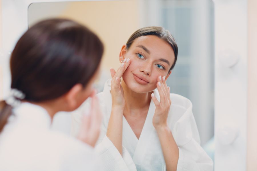 girl looking at face acne-free