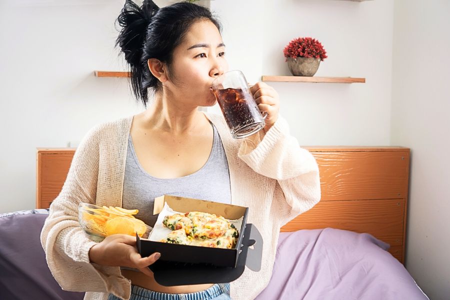 woman eating unhealthy foods