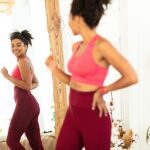 woman looking at her body for weight loss in the mirror