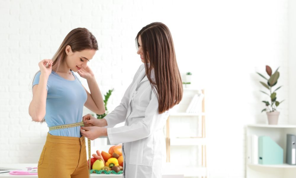 woman being measured for weight loss