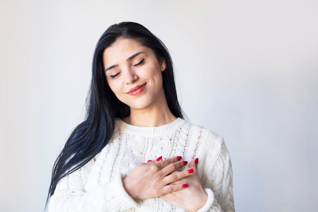 woman touching heart implying good health