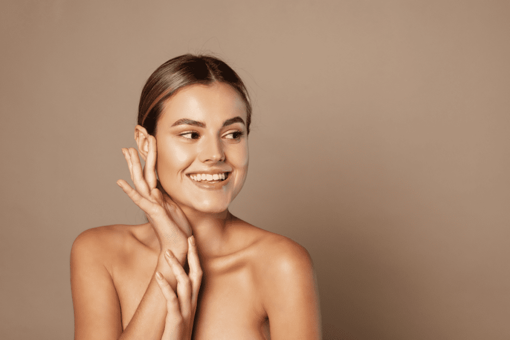 Smiling woman with glowing skin showing the benefits of consistent seasonal IV therapy for long-term wellness.
