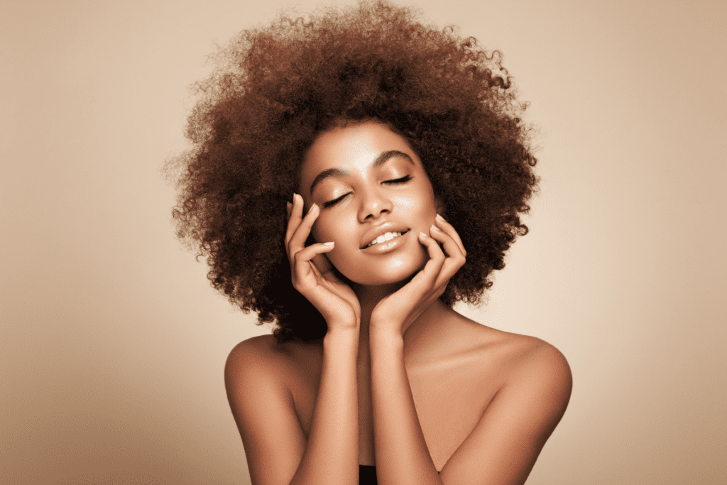 Woman with healthy hair and skin illustrating how seasonal IV therapy adapts to changing environmental factors.