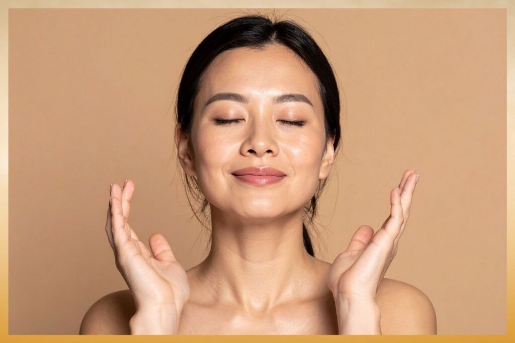 A woman with closed eyes and a serene smile cups her face, enjoying the rejuvenating effects of IV therapy for skin and self-care.