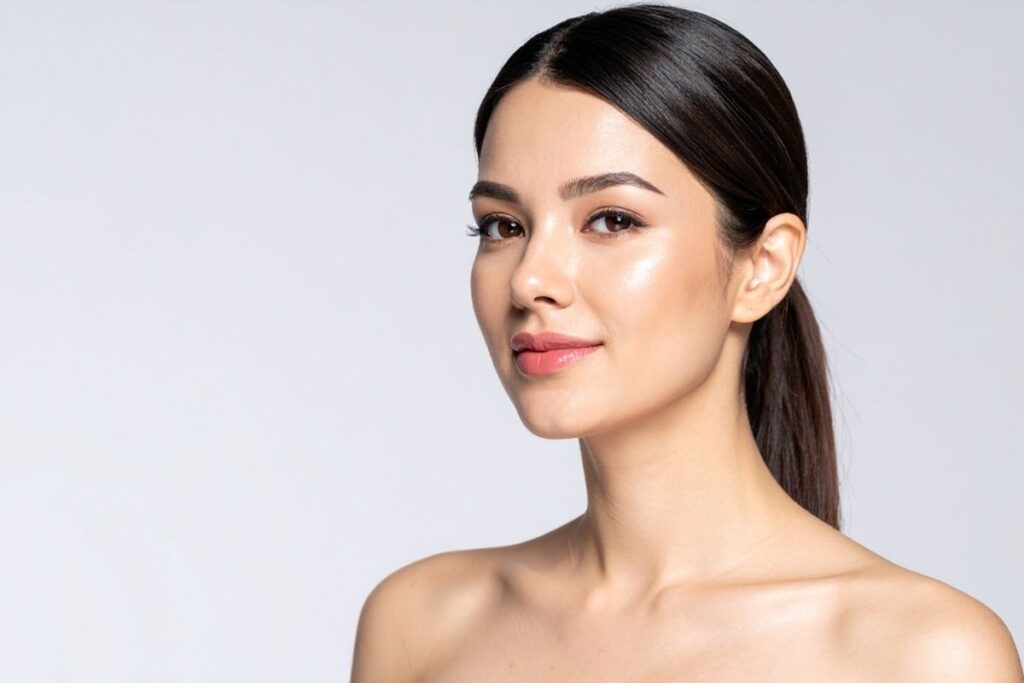 Confident woman with a smooth, healthy complexion, demonstrating the aesthetic goals often discussed when debunking IV therapy misconceptions.