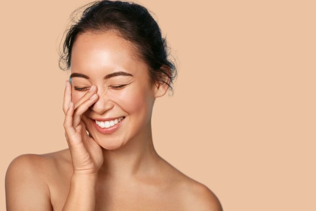 Woman with glowing skin demonstrating the aesthetic results of IV hydration and wellness at Saint Aesthetix.