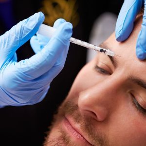Baby Botox shot in the forehead of a man