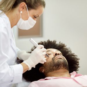 Dermatologist Microneedling a Man