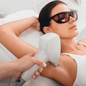 The woman is having laser hair removal performed on her armpit