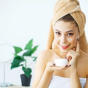 a girl applying a rejuvenation cream after taking a bath