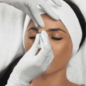 hands giving botox to a woman