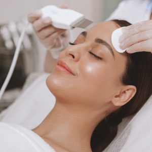 Beautiful young woman getting facial skincare treatment