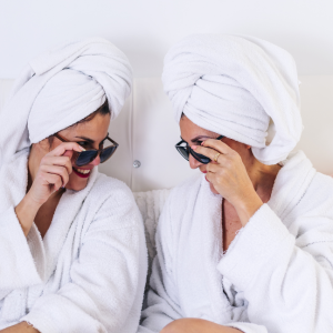 two ladies wearing shades and white robe in spa