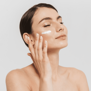 woman applying skincare to her face
